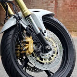 White Honda Hornet 600 — front wheel and gold caliper
