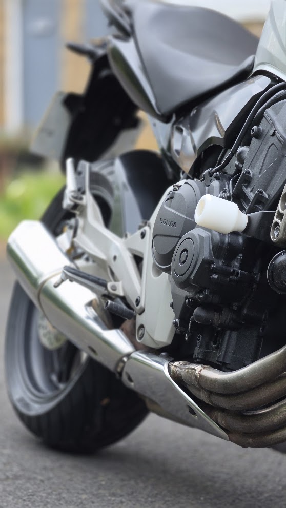 White Honda Hornet 600 — engine and exhaust close-up